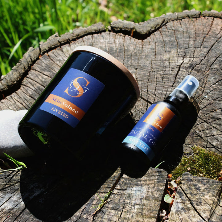 Two bottles with labels on a wooden stump outdoors
